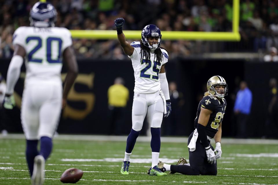 Richard Sherman reacts to breaking up a pass vs. the Saints. He didn't get fined. We think. (Getty Images)