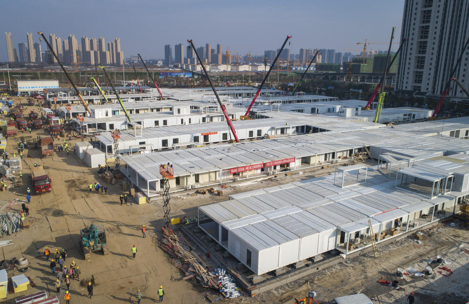 In this Feb. 4, 2020, photo released by China's Xinhua News Agency, construction workers labor at the Leishenshan Hospital, the second temporary field hospital being built in Wuhan in central China's Hubei Province. Deaths from a new virus rose to 490 in mainland China on Wednesday while new cases on a Japanese cruise ship, in Hong Kong and in other places showed the increasing spread of the outbreak and renewed attention toward containing it. (Xiao Yijiu/Xinhua via AP)