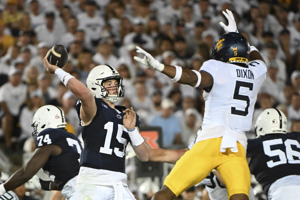 Penn State quarterback Drew Allar (15) passes while pressured by West Virginia linebacker Lance Dixon (5) during the second half of an NCAA college football game, Saturday, Sept. 2, 2023, in State College, Pa. (AP Photo/Barry Reeger)