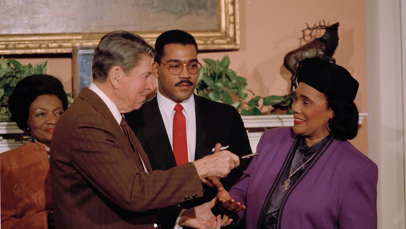 President Reagan hands Coretta Scott King the pen he used to sign the Martin Luther King, Jr. Day proclamation at the White House, Jan. 12, 1988.