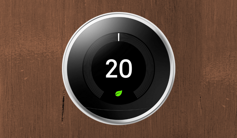 A round LCD screen thermostat which says 