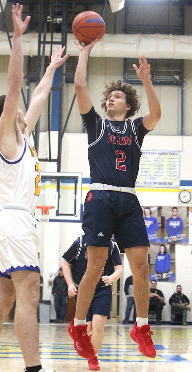 BNL junior Colten Leach lofts a jumper over Mitchell's Kale England Tuesday night. Leach has 12 points and 12 rebounds in the Stars' road win.