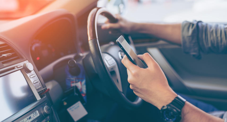 Drivers and riders in NSW who use mobile phones illegally will now be penalised an extra demerit point. Source: File image, Getty