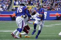 New York Giants quarterback Daniel Jones (8), right, runs the ball during the second half of an NFL football game against the Washington Commanders, Sunday, Dec. 4, 2022, in East Rutherford, N.J. (AP Photo/John Minchillo)