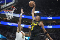 Utah Jazz guard Talen Horton-Tucker (5) goes to the basket as Denver Nuggets forward Zeke Nnaji (22) defends during the second half of an NBA basketball game Tuesday, April 9, 2024, in Salt Lake City. (AP Photo/Rick Bowmer)