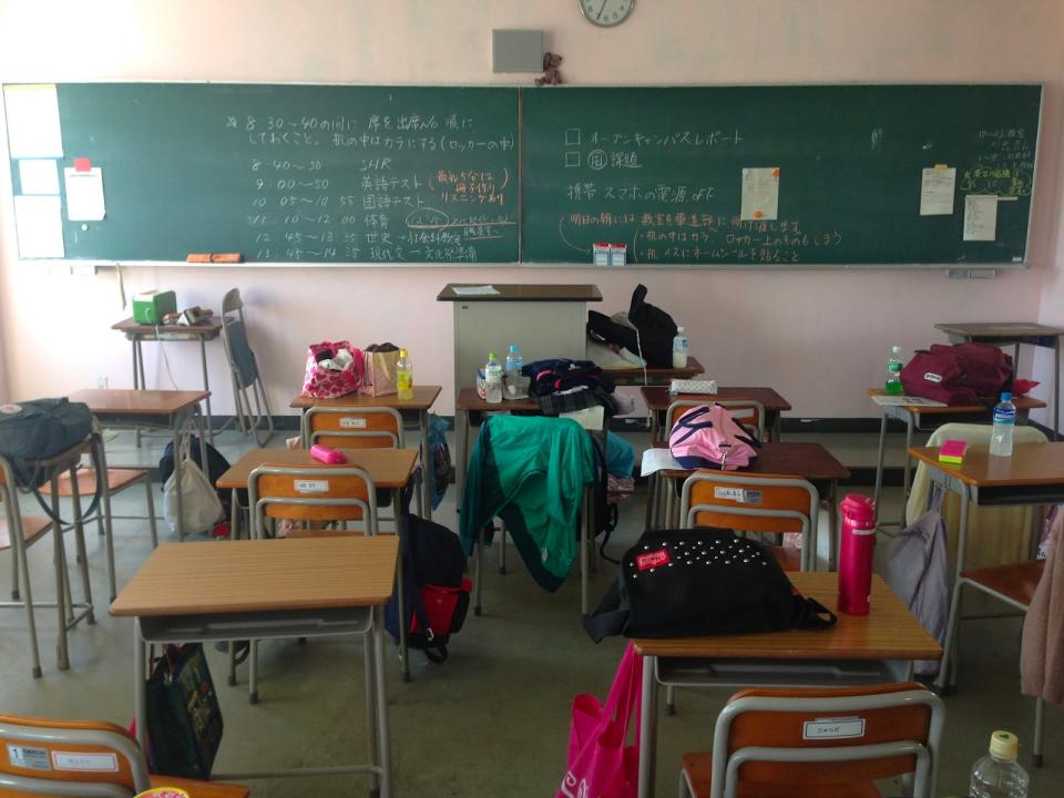 japanese classroom filled with coats, bags, and school supplies
