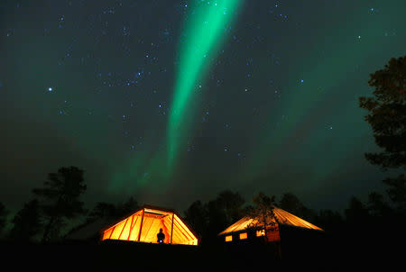 FILE PHOTO: The Aurora Borealis (Northern Lights) is seen over a mountain camp north of the Arctic Circle, near the village of Mestervik late October 1, 2014. Picture taken October 1, 2014. REUTERS/Yannis Behrakis/File Photo