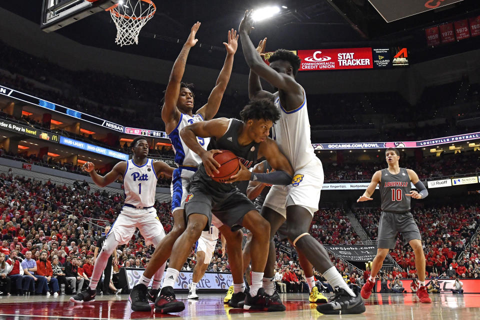 Pittsburgh guard Au'Diese Toney, left, and forward Eric Hamilton, right, trap Louisville forward Dwayne Sutton (24) along the baseline during the second half of an NCAA college basketball game in Louisville, Ky., Friday, Dec. 6, 2019. Louisville won 64-46. (AP Photo/Timothy D. Easley)