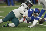 Philadelphia Eagles defensive end Brandon Graham (55) forces a fumble by New York Giants quarterback Tyrod Taylor (2) during the fourth quarter of an NFL football game, Sunday, Dec. 11, 2022, in East Rutherford, N.J. (AP Photo/Bryan Woolston)