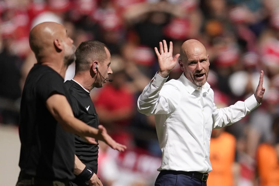 Manchester City's head coach Pep Guardiola, left, agrees with Manchester United's head coach Erik ten Hag during the English FA Cup final soccer match between Manchester City and Manchester United at Wembley Stadium in London, Saturday, June 3, 2023. (AP Photo/Dave Thompson)