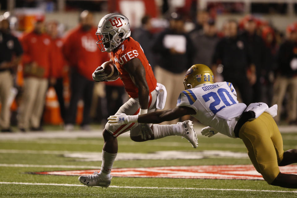 Utah running back Devonta'e Henry-Cole (7) out runs UCLA defensive back Elisha Guidry (20) on his way to a touchdown in the second half during an NCAA college football game Saturday, Nov. 16, 2019, in Salt Lake City. (AP Photo/Rick Bowmer)