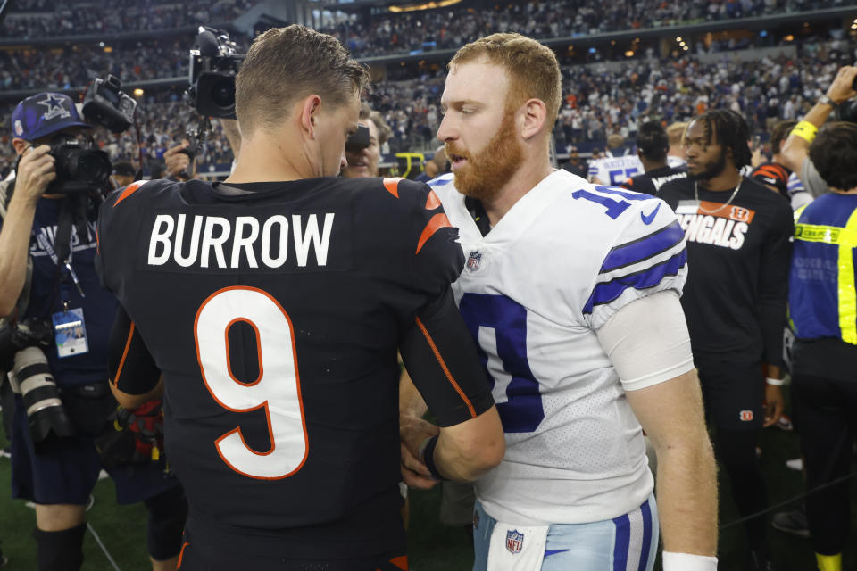 Cincinnati Bengals quarterback Joe Burrow (9) talks with Dallas Cowboys quarterback Cooper Rush (10) after their NFL football game Sunday, Sept. 18, 2022, in Arlington, Tx. (AP Photo/Michael Ainsworth)