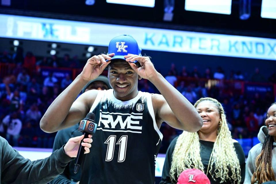 Karter Knox puts a Kentucky hat on his head to signify his commitment to the Wildcats during halftime of an Overtime Elite Finals game on Saturday at OTE Arena in Atlanta. Knox is a younger brother of Kevin Knox, a former one-and-done star with the Wildcats.