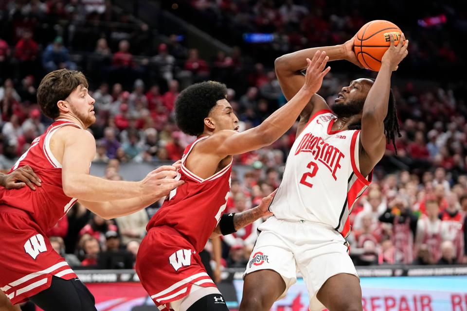 Jan 10, 2024; Columbus, Ohio, USA; Ohio State Buckeyes guard Bruce Thornton (2) tries to shoot over Wisconsin Badgers guard Chucky Hepburn (23) and Wisconsin Badgers forward Carter Gilmore (14) during the second half of the NCAA men’s basketball game at Value City Arena. Ohio State lost 71-60.