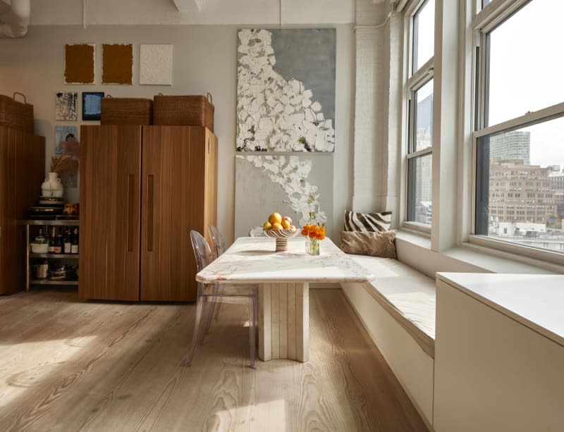 White marble table near sunny window in New York City apartment.