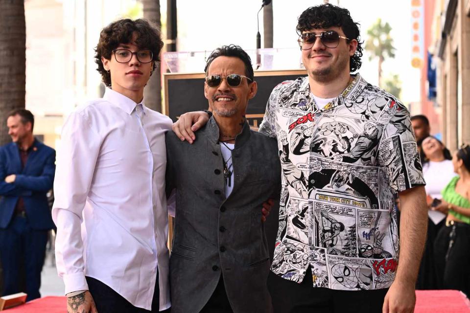 <p>PATRICK T. FALLON/AFP via Getty</p> Marc Anthony and sons Ryan and Cristian