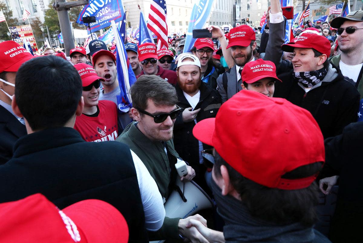 Supporters of the America First ideology and U.S. President Donald Trump cheer on Nick Fuentes, a leader of the America First movement and a white nationalist, as he makes his way through the crowd for a speech during the "Stop the Steal" and "Million MAGA March" protests after the 2020 U.S. presidential election was called for Democratic candidate Joe Biden, in Washington on Nov. 14, 2020.