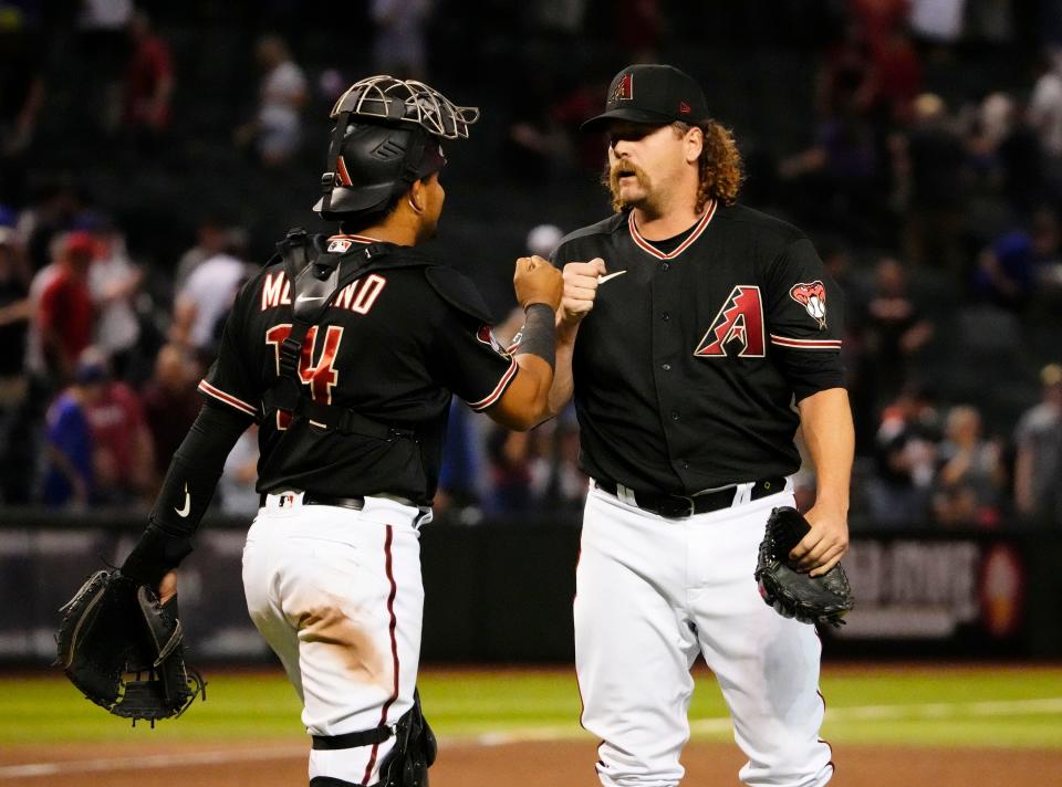 Arizona Diamondbacks catcher Gabriel Moreno (14) greets relief pitcher Andrew Chafin (57) after defeating the Kansas City Royals 5-4 at Chase Field in Phoenix on April 24, 2023.