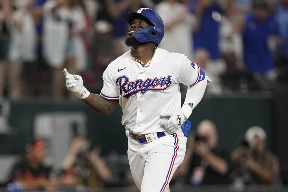 Texas Rangers' Adolis Garcia gestures after hitting a three-run home run in the second inning of Game 3 of a baseball AL Division Series against the Baltimore Orioles on Tuesday, Oct. 10, 2023, in Arlington, Texas. (AP Photo/Tony Gutierrez )