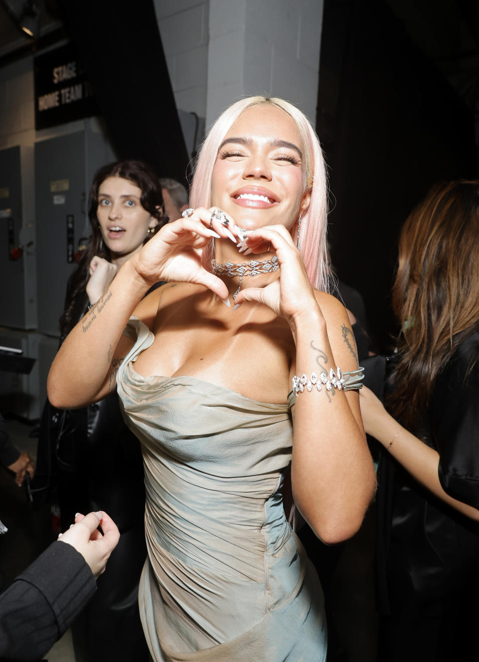 Closeup of Karol G making a heart with her hands