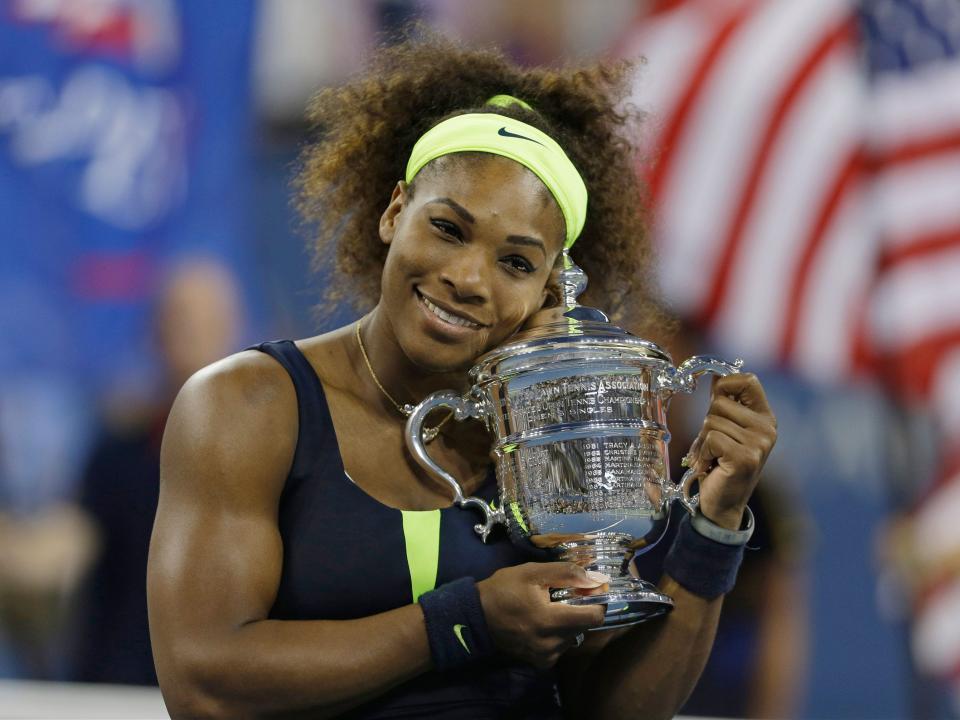 Serena Williams celebrates with the trophy after winning the 2012 US Open.