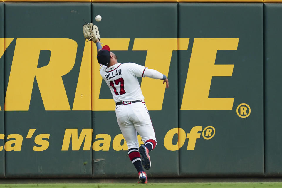 Atlanta Braves left fielder Kevin Pillar catches a fly ball by New York Mets' Brandon Nimmo in the first inning of a baseball game Monday, Aug. 21, 2023, in Atlanta. (AP Photo/John Bazemore)