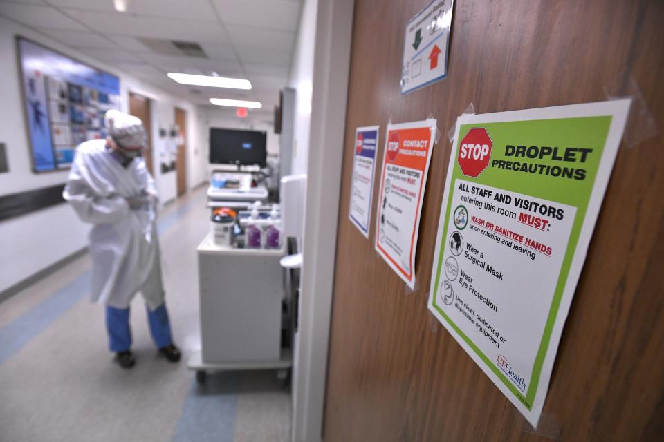 Signs on all the patient doors remind staff and visitors of precautions to prevent the spread of the Coronavirus in the COVID-19 ward at UF Health's downtown Jacksonville campus Friday, July 30, 2021. The second surge of COVID-19 infections in Jacksonville is stretching the capacity of area medical facilities to care for patients.