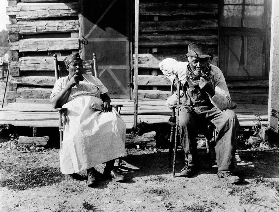 An older couple rest at the end of a workday on a plantation