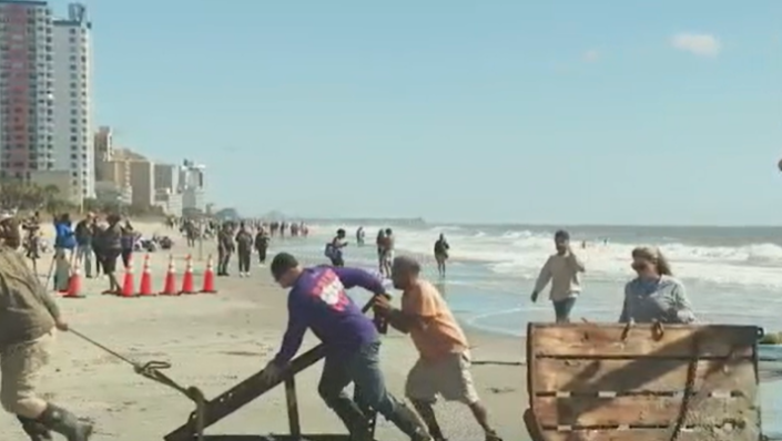 Volunteers removed heavy wings or outriggers used to drag nets and for stabilization.