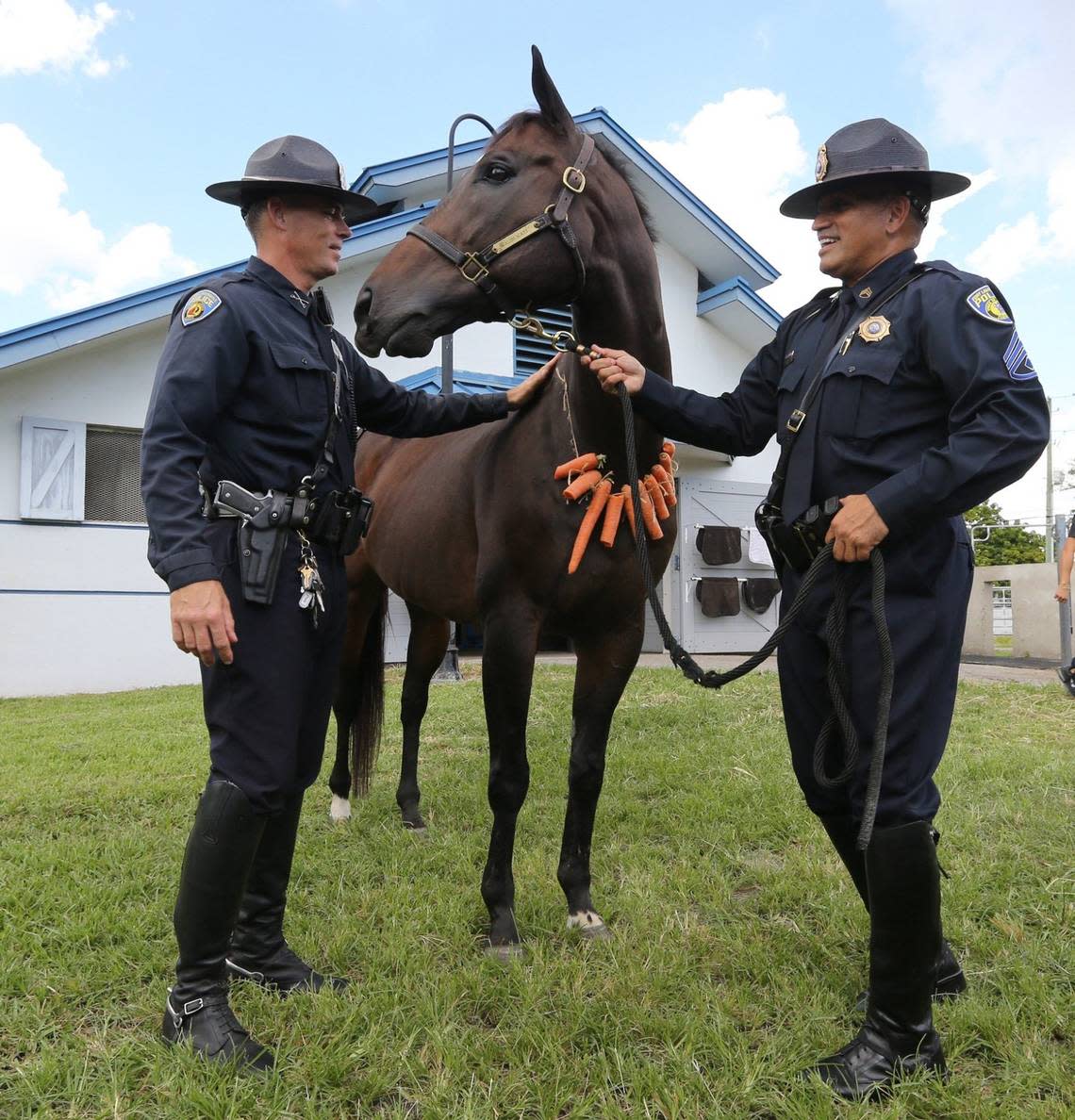 Officer Eric Sweet and Sgt. Hugo Fontalvo with retiring Fort Lauderdale police mounted patrol horse Zachariah, October 7, 2015.