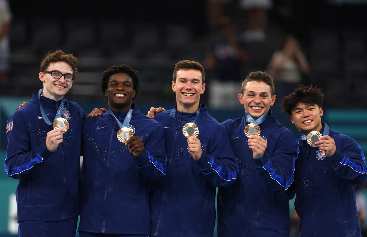 Paris 2024 Olympics - Artistic Gymnastics - Men's Team Victory Ceremony - Bercy Arena, Paris, France - July 29, 2024. Bronze medallist's Stephen Nedoroscik, Paul Juda, Brody Malone, Frederick Richard and Asher Hong of United States celebrate on the podium with their medals. REUTERS/Hannah Mckay