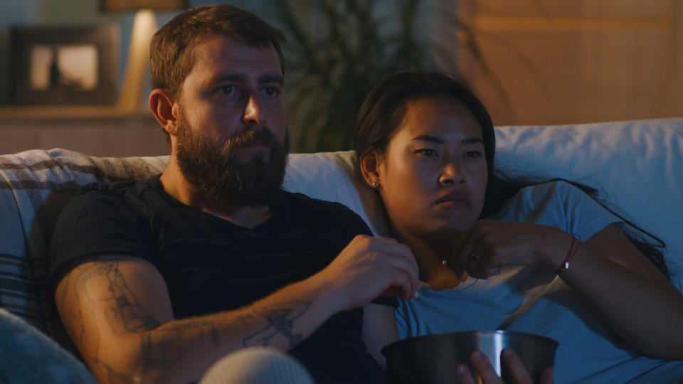 A couple watching TV inside their home