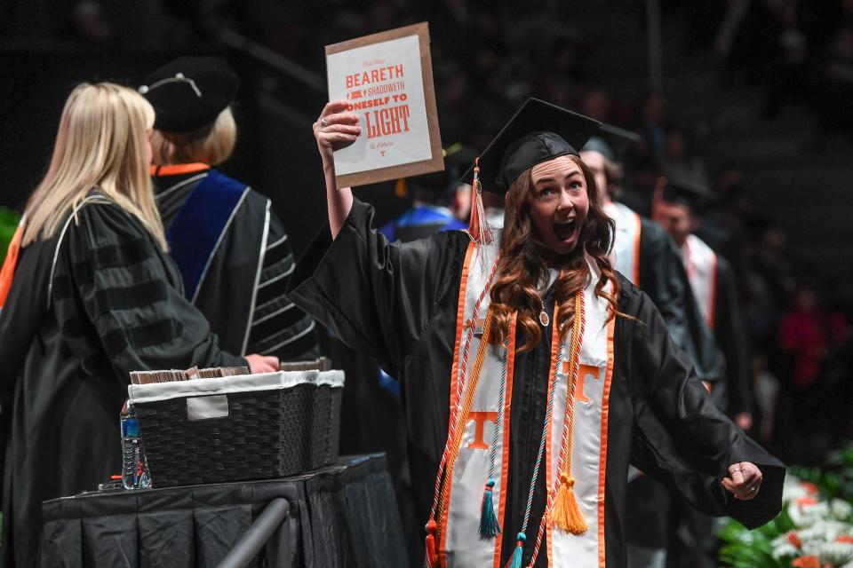 A new University of Tennessee Knoxville graduate shows her diploma to her family during the undergraduate commencement ceremony at Thompson-Boling Arena at Food City Center on Dec. 15. Nearly every commencement ceremony happening May 16-19 will be held at the arena.