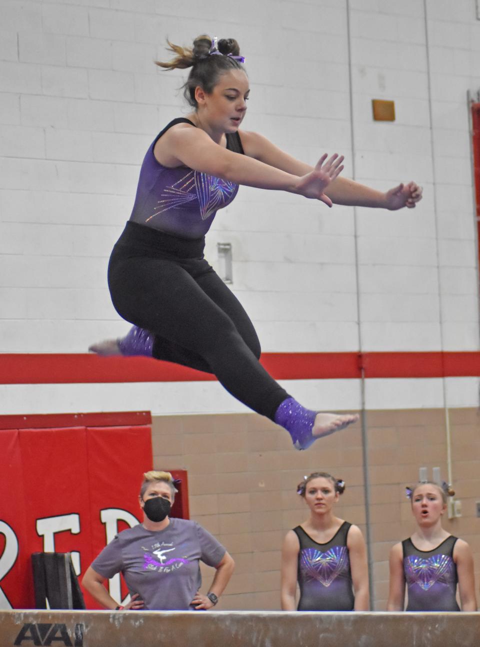 Coldwater's Carly Krzyzanski flies high on the balance beam Saturday at the Stick It for a Cure Invite