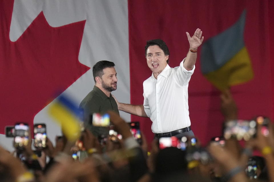 Prime Minister Justin Trudeau, right, introduces Ukrainian President Volodymyr Zelenskyy at a rally at the Fort York Armoury in Toronto on Friday, Sept. 22, 2023. (Nathan Denette/The Canadian Press via AP)