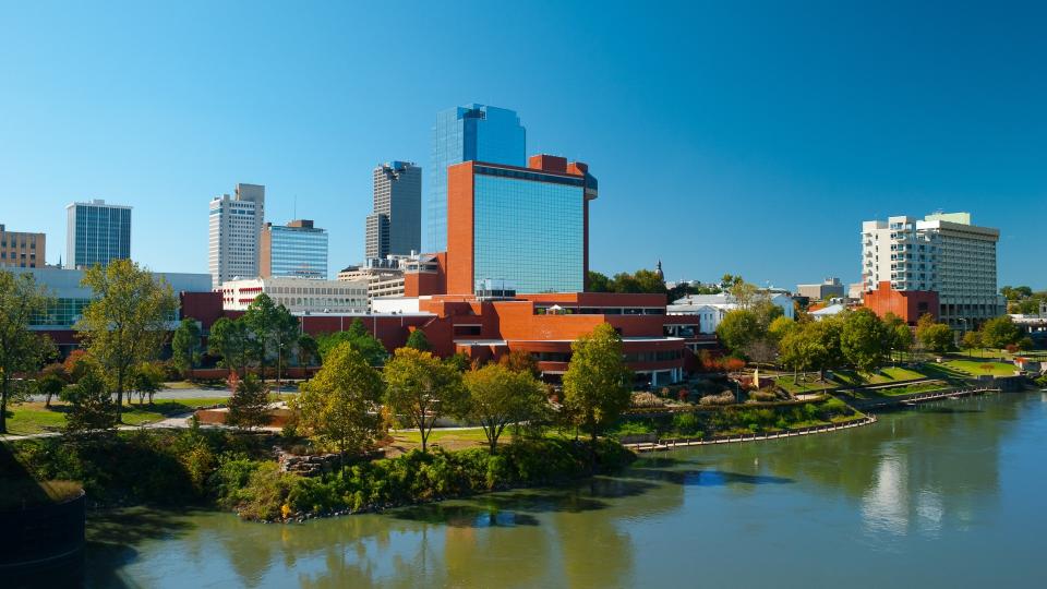 Downtown Little Rock skyline with the Arkansas River in the foreground.
