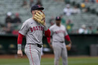 Boston Red Sox shortstop Trevor Story, left, reacts after his throwing error during the eighth inning of a baseball game against the Oakland Athletics, Wednesday, April 3, 2024, in Oakland, Calif. (AP Photo/Godofredo A. Vásquez)