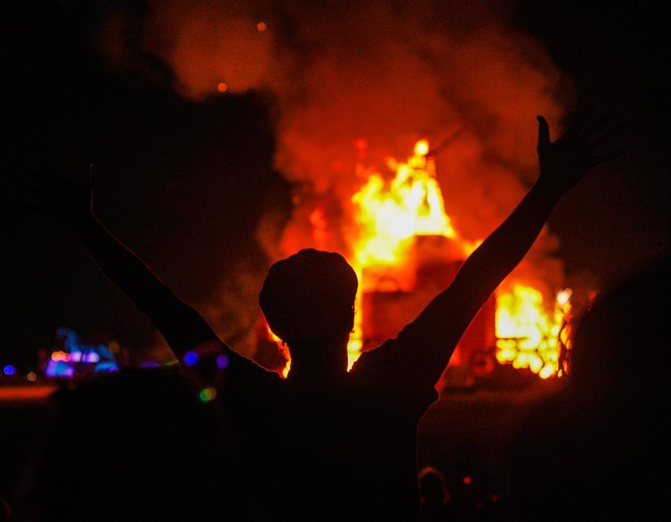 A person cheers during the Man burn at Burning Man on Labor Day.