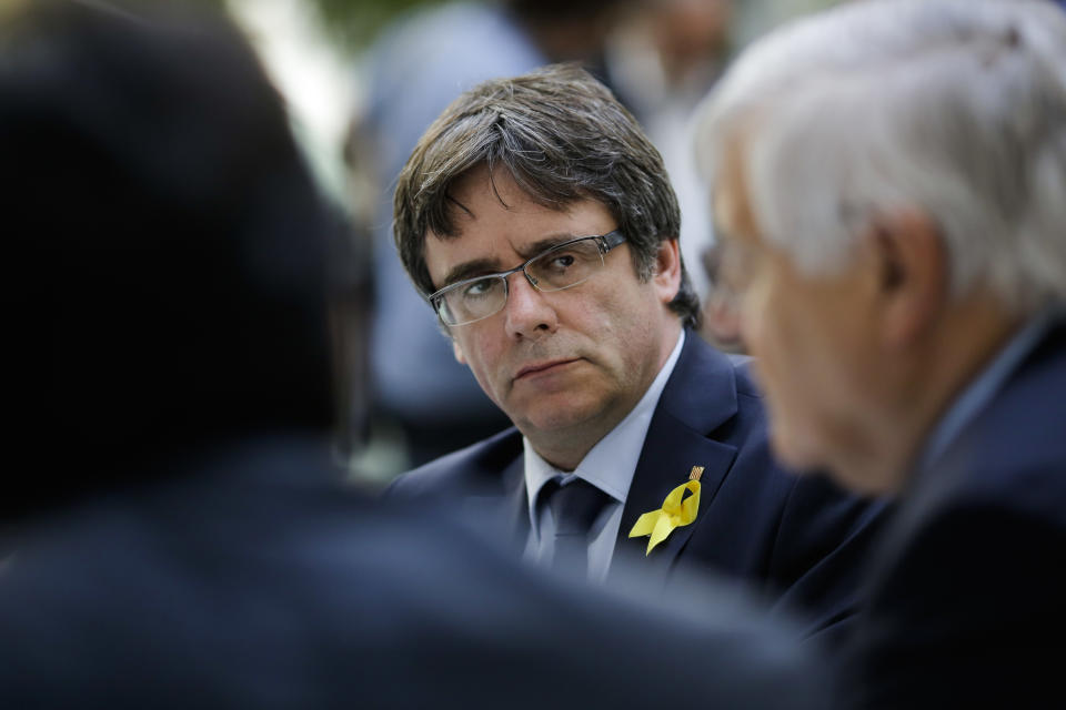 Former Catalan leader Carles Puigdemont, center, waits for the beginning of a news conference in Berlin, Germany, Wednesday, July 25, 2018. (AP Photo/Markus Schreiber)