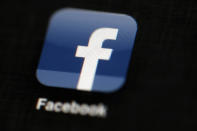 FILE - This May 16, 2012, file photo, shows the Facebook logo displayed on an iPad. Facebook in India dithered in curbing hate speech and anti-Muslim content on its platform and lacked enough local language moderators to stop misinformation that at times led to real-world violence, according to leaked documents obtained by The Associated Press. (AP Photo/Matt Rourke, File)