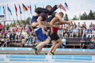 FILE PHOTO: Tia Rope and Joonas Saukkonen (L) and Katja Hyvarinen and Jukka Podduikin, all of Finland, compete during the Wife Carrying World Championships in Sonkajarvi, Finland July 2, 2016. Lehtikuva/Timo Hartikainen/via REUTERS/File Photo