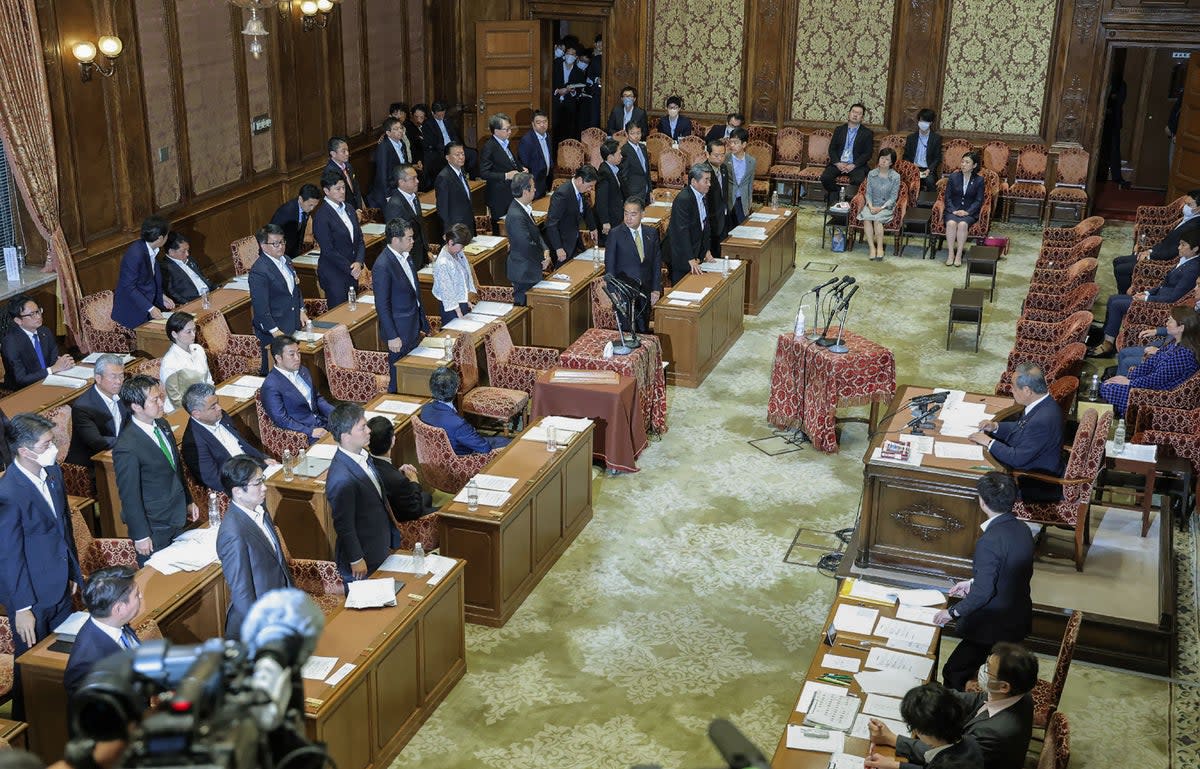 Members of the House of Representatives cabinet committee stand as they vote in favour of the ruling party’s amendment to a bill to promote the understanding of LGBT and other sexual minorities, at the parliament building in Tokyo on 9 June 2023 (JIJI Press/AFP via Getty Images)