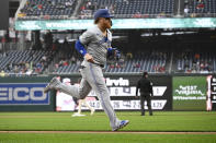 Toronto Blue Jays' Justin Turner runs home to score on a fielder's choice hit into by Daniel Vogelbach during the first inning of a baseball game, against the Washington Nationals, Saturday, May 4, 2024, in Washington. (AP Photo/Nick Wass)