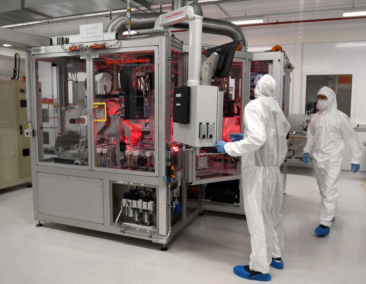 Employees of German carmaker Volkswagen work in a production line of VW' new battery plant in Salzgitter, Germany September 23, 2019. Picture taken through a window. REUTERS/Fabian Bimmer