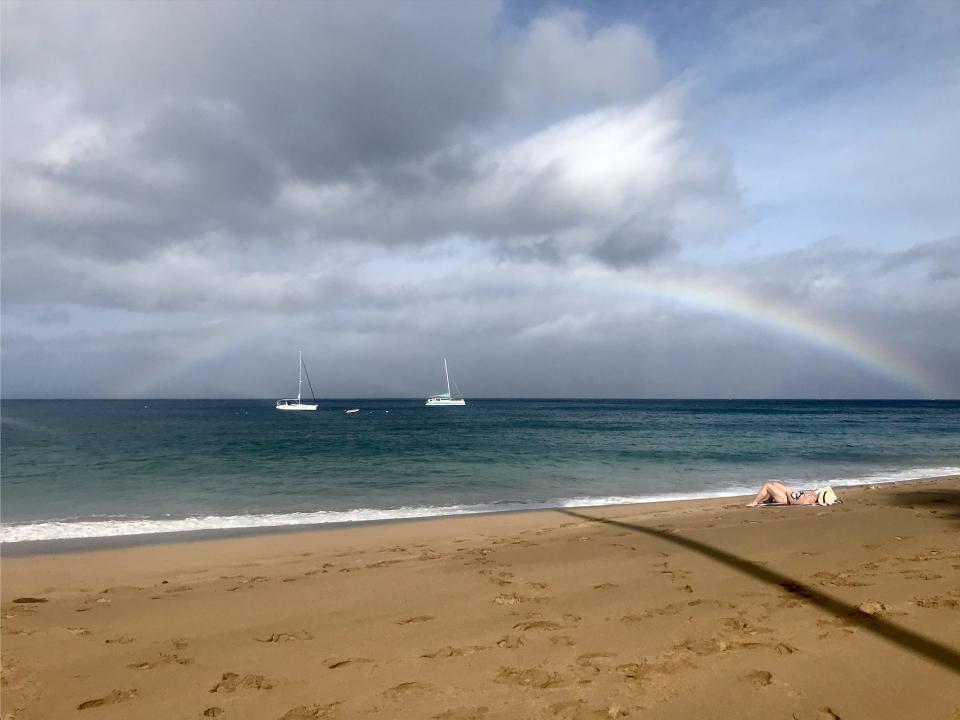A view of the water, sky, and a rainbow at Kaanapali Beach