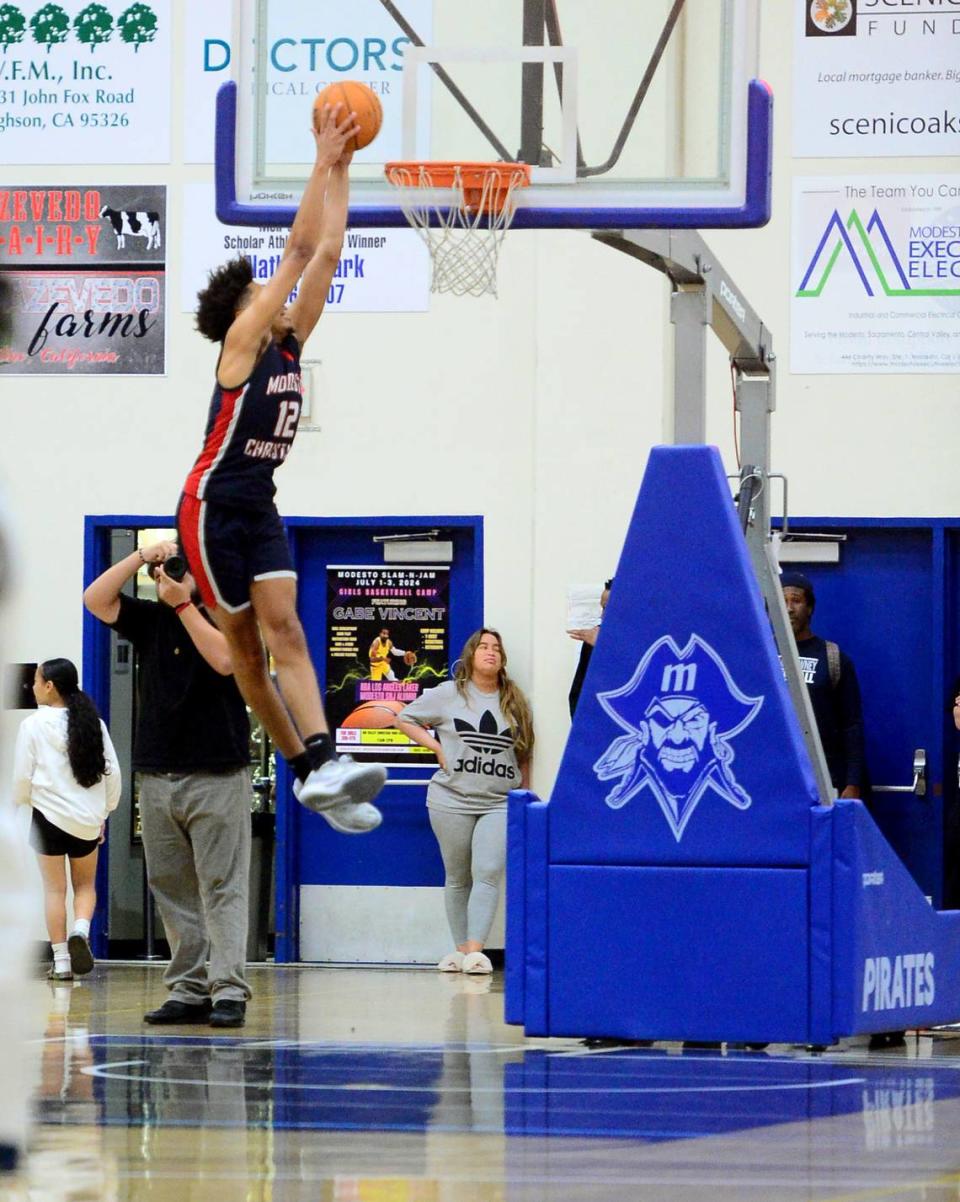 Modesto Christians Marcus Washington (12) dunks the ball during the 27th Annual Six County All Star Senior Basketball Classic Boys game at Modesto Junior College in Modesto California on April 27, 2024. The Red team beat the Blue team 81-79.