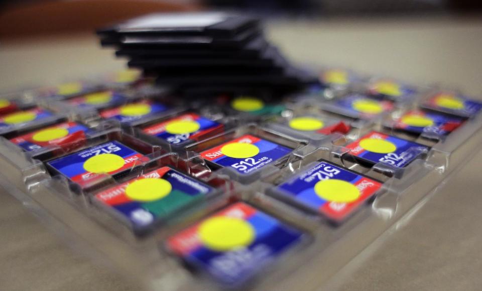 In this Thursday, March 9, 2017 photo, a stack of zip disks and a tray of compact flash cards sit at the Bexar County Elections office, in San Antonio. Bexar County's voting equipment is among the oldest in America's second-largest state and will have to be replaced soon. But money to do so is scarce and that scenario is playing out around the country. (AP Photo/Eric Gay)