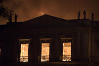 Fire burns inside the 200-year-old National Museum of Brazil, in Rio de Janeiro, Sunday, Sept. 2, 2018. According to its website, the museum has thousands of items related to the history of Brazil and other countries. The museum is part of the Federal University of Rio de Janeiro (AP Photo/Leo Correa)