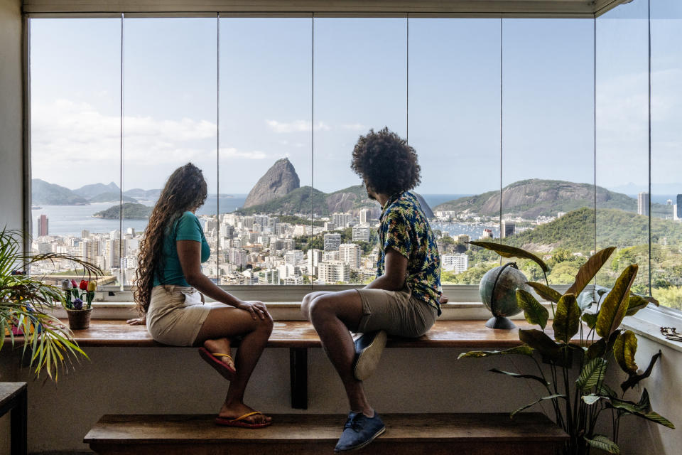 A couple looking out at a city from their window