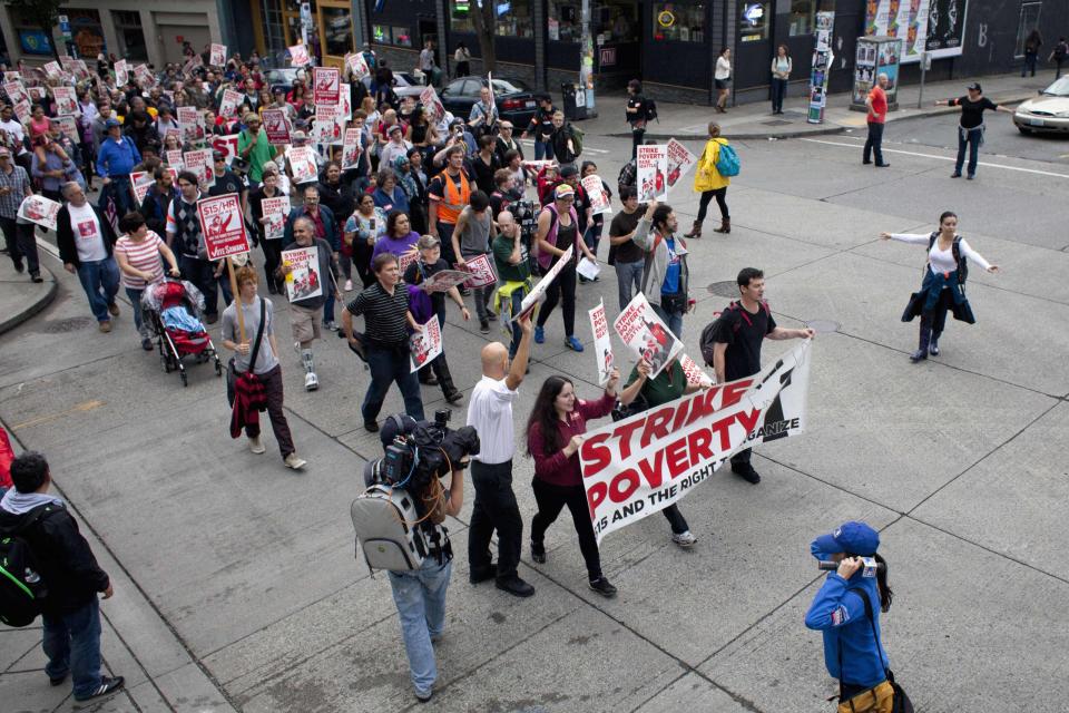 Demonstrators make their way up Pike Street during a strike aimed at the fast-food industry and the minimum wage in Seattle, Washington August 29, 2013. Fast-food workers went on strike and protested outside restaurants in 60 U.S. cities on Thursday, in the largest protest of an almost year-long campaign to raise service sector wages. REUTERS/David Ryder (UNITED STATES - Tags: CIVIL UNREST BUSINESS EMPLOYMENT FOOD)